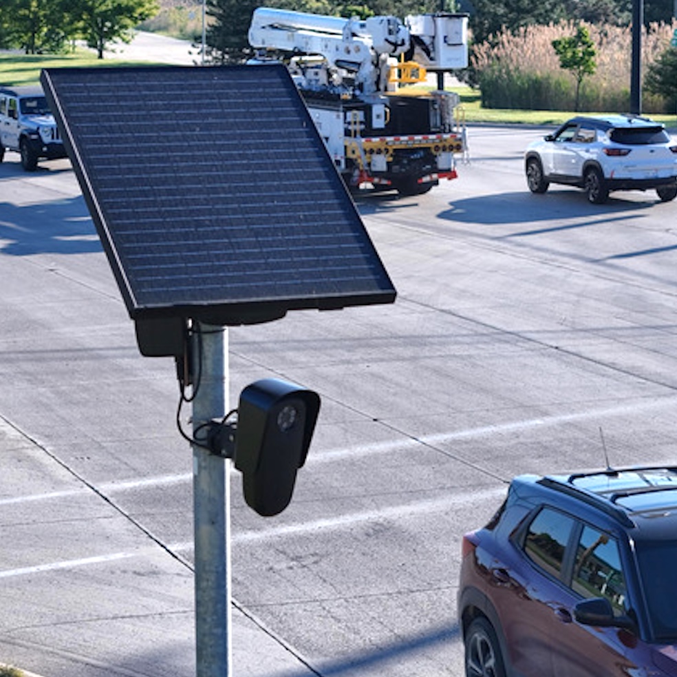 A Flock camera surveils passing traffic